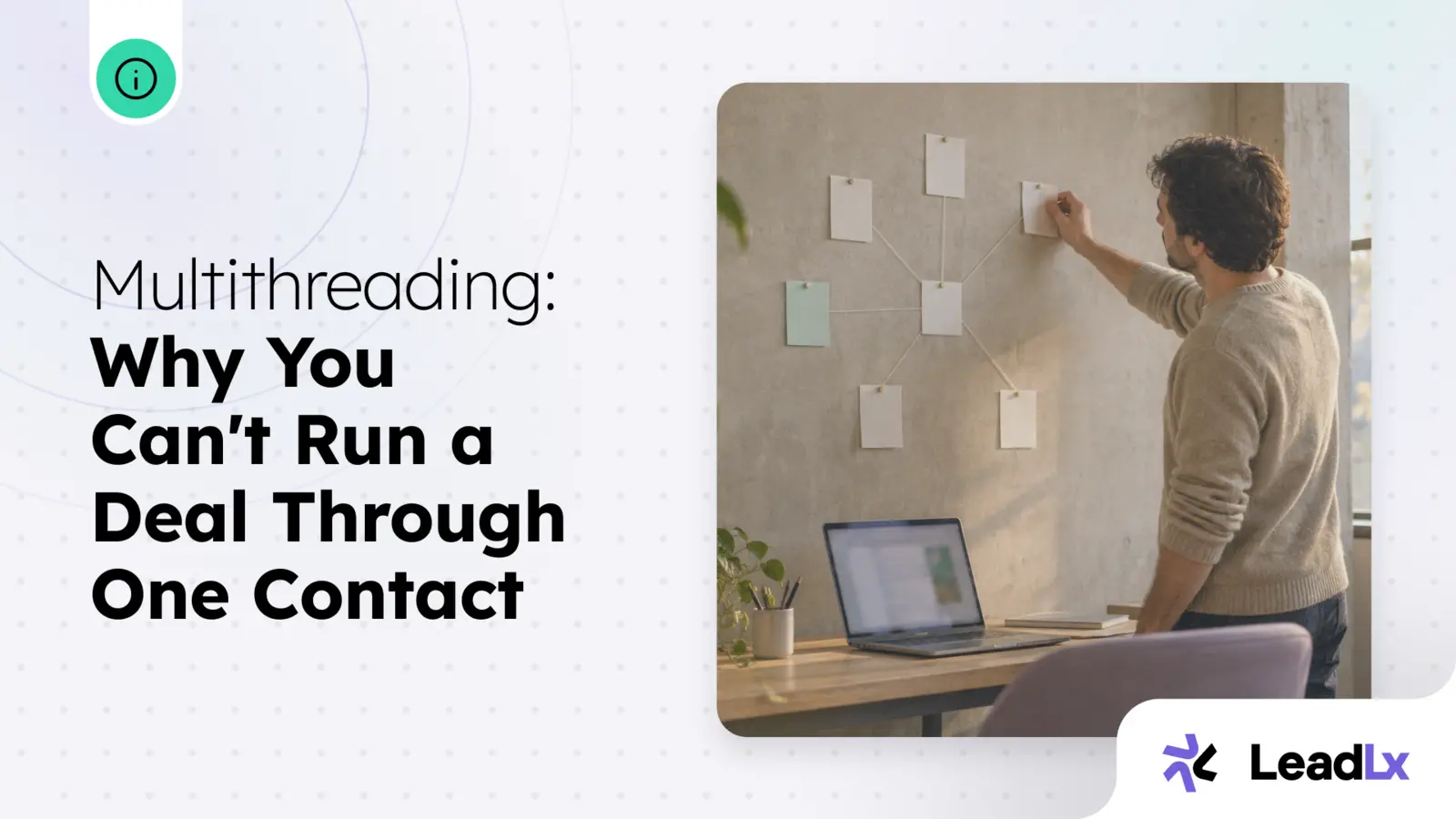 A man pinning note cards into a connected web on a wall above his desk, mapping out how the cards relate to each other